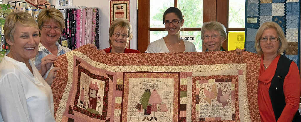 Lyn Johnson, Sharon Campbell, Ros Robinson, Rebecca Grayson, Liz Brown and Glenis Pugliese with the quilt made by Anne Briggs.